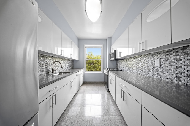45-08 40th St Unit F32, Sunnyside, NY 11104 - kitchen with a sink, white cabinets, stainless steel appliances, and granite finish floor
