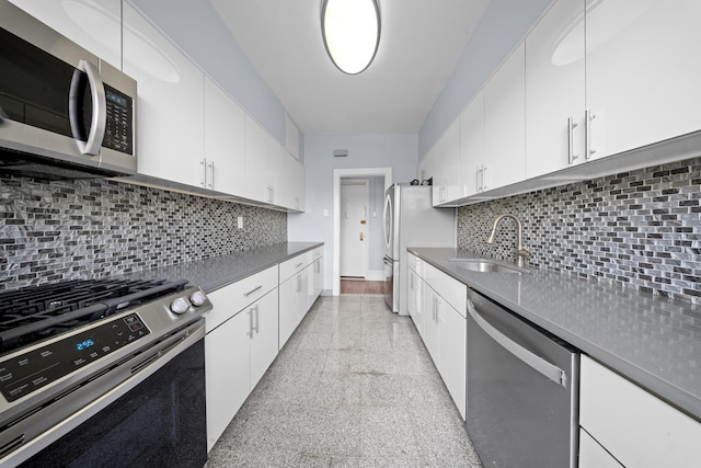 45-08 40th St Unit F32, Sunnyside, NY 11104 - kitchen with backsplash, granite finish floor, a sink, stainless steel appliances, and white cabinetry