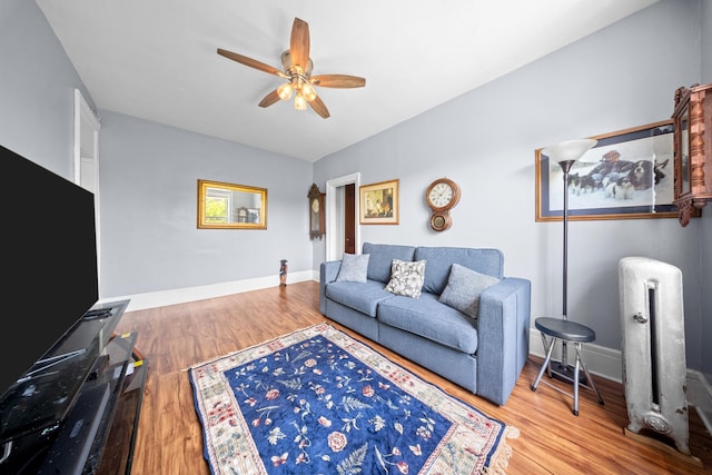 45-08 40th St Unit F32, Sunnyside, NY 11104 - living room featuring baseboards, ceiling fan, wood finished floors, and radiator