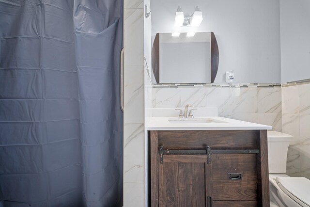 45-08 40th St Unit F32, Sunnyside, NY 11104 - bathroom featuring toilet, tile walls, and vanity
