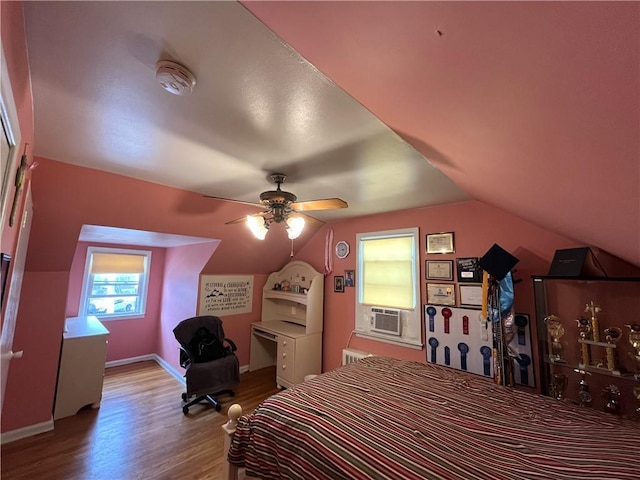 bedroom with ceiling fan, light hardwood / wood-style floors, cooling unit, and lofted ceiling