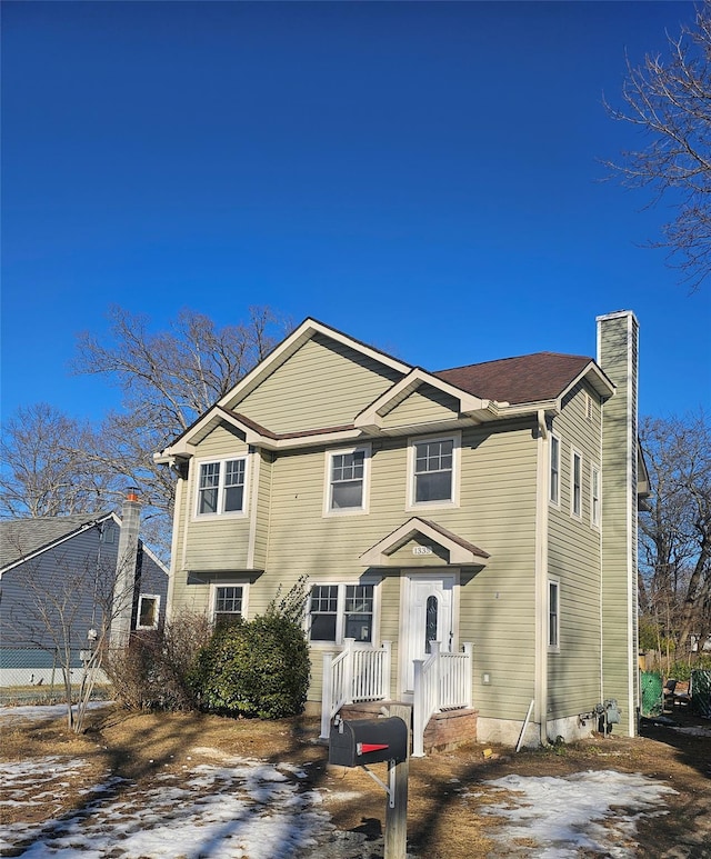 view of front of house featuring a chimney