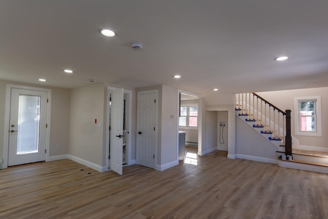 foyer with light wood-style floors, recessed lighting, stairway, and baseboards