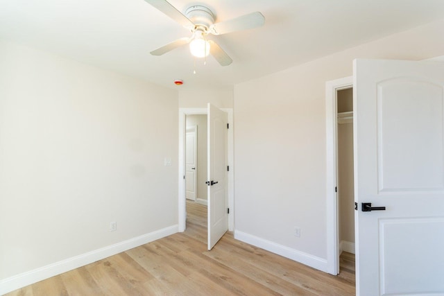 unfurnished bedroom with light wood-style floors, baseboards, and a ceiling fan