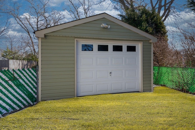 detached garage featuring fence