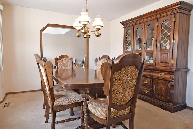 dining space with an inviting chandelier, baseboards, visible vents, and light colored carpet