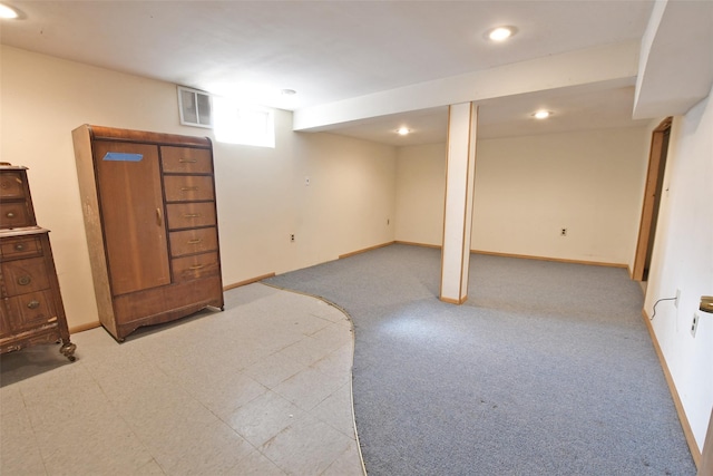 basement featuring light carpet, recessed lighting, visible vents, and baseboards