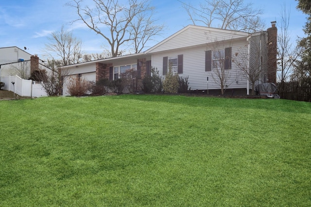 single story home with a chimney, fence, and a front lawn