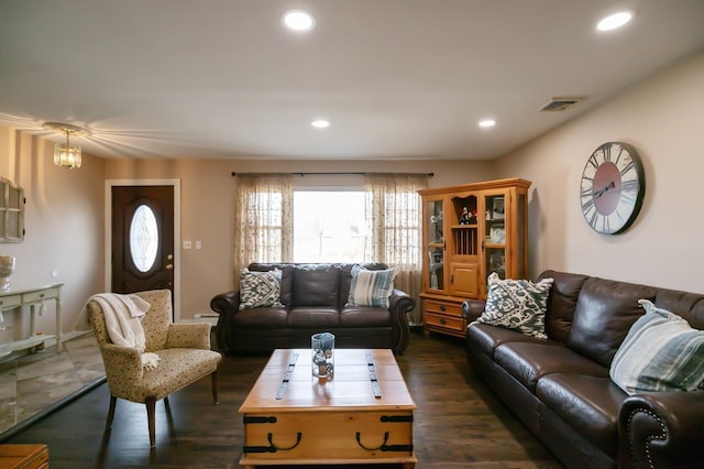 living area with dark wood finished floors, visible vents, and recessed lighting