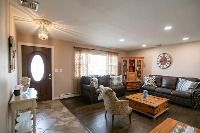 living room featuring a baseboard heating unit, recessed lighting, visible vents, and baseboards