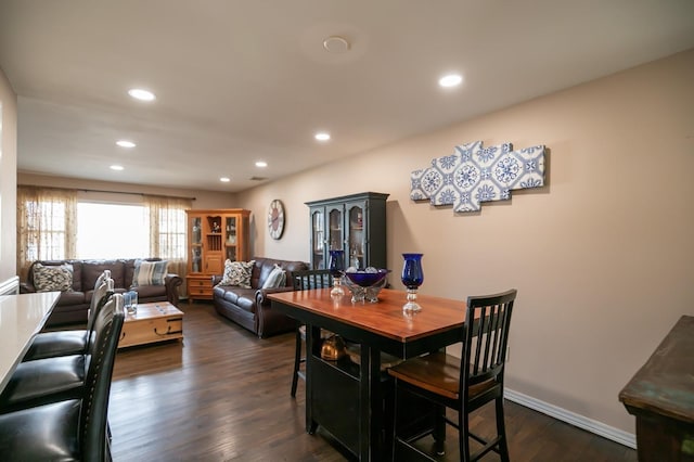 dining space with recessed lighting, dark wood finished floors, and baseboards