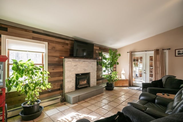 living area with vaulted ceiling, french doors, a baseboard radiator, and a healthy amount of sunlight