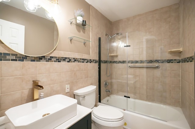 bathroom featuring shower / bath combination with glass door, tile walls, toilet, and vanity