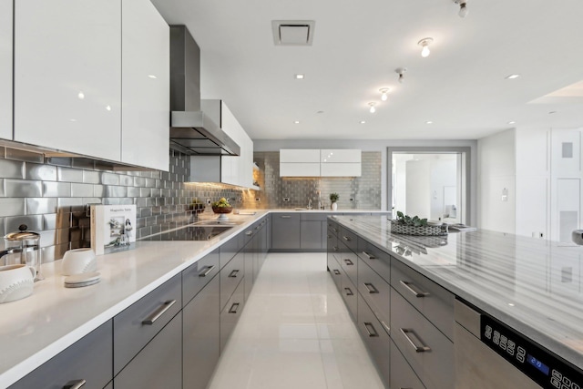 kitchen with black electric stovetop, gray cabinetry, wall chimney range hood, stainless steel dishwasher, and modern cabinets