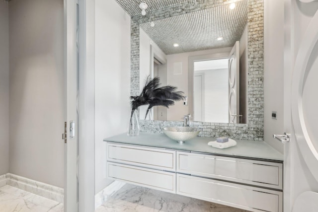 bathroom with marble finish floor and vanity