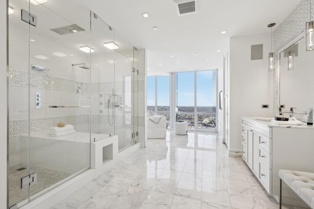 bathroom featuring a stall shower, expansive windows, visible vents, and vanity