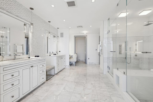 full bathroom with marble finish floor, two vanities, visible vents, a sink, and a shower stall