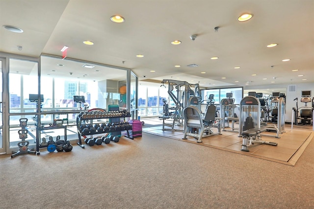 exercise room featuring recessed lighting, floor to ceiling windows, and visible vents