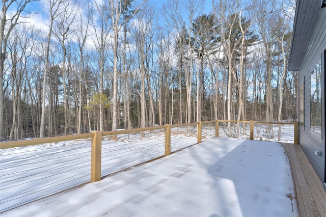 yard layered in snow with a deck