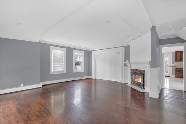 unfurnished living room with dark wood-type flooring, a fireplace with flush hearth, baseboards, ornamental molding, and baseboard heating