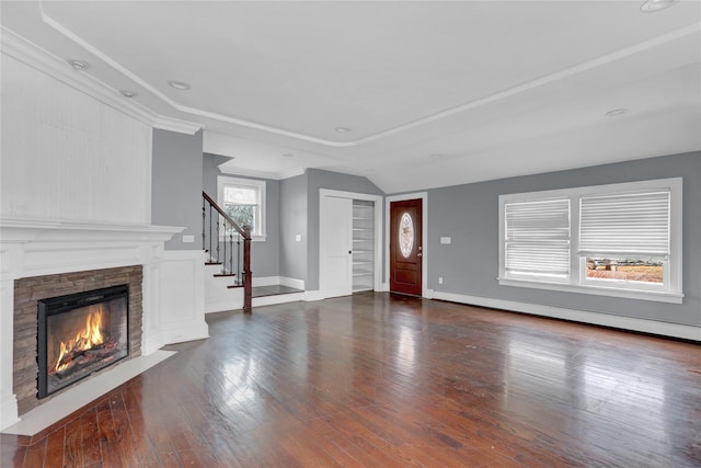 entryway with baseboards, a baseboard radiator, stairway, dark wood-style flooring, and a fireplace