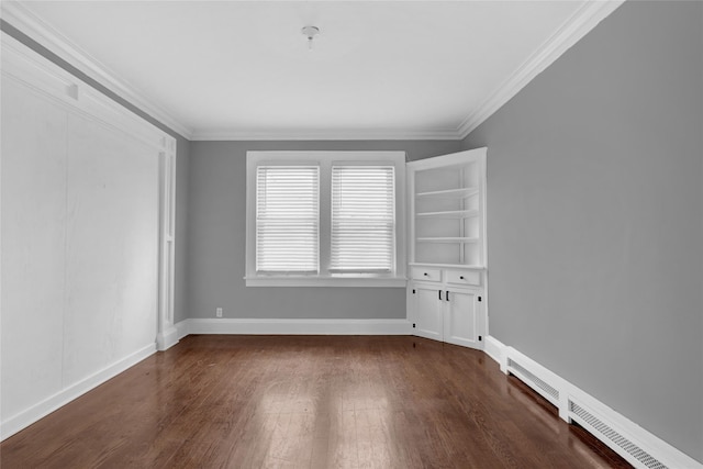 empty room featuring ornamental molding, dark wood finished floors, and baseboards