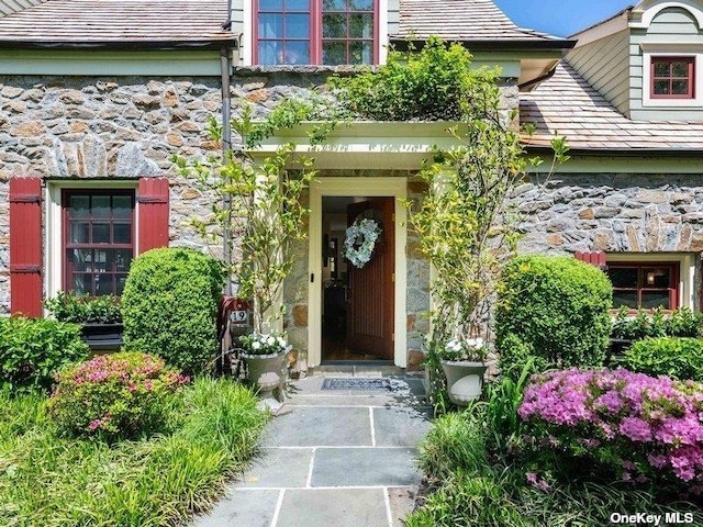 entrance to property with stone siding