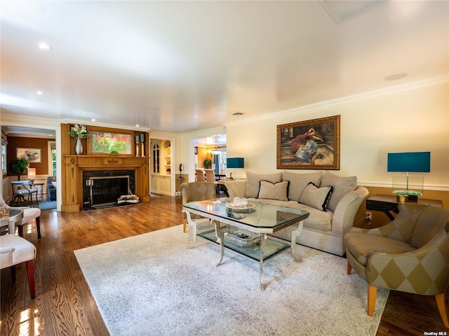 living room featuring recessed lighting, crown molding, dark wood-style flooring, and a high end fireplace