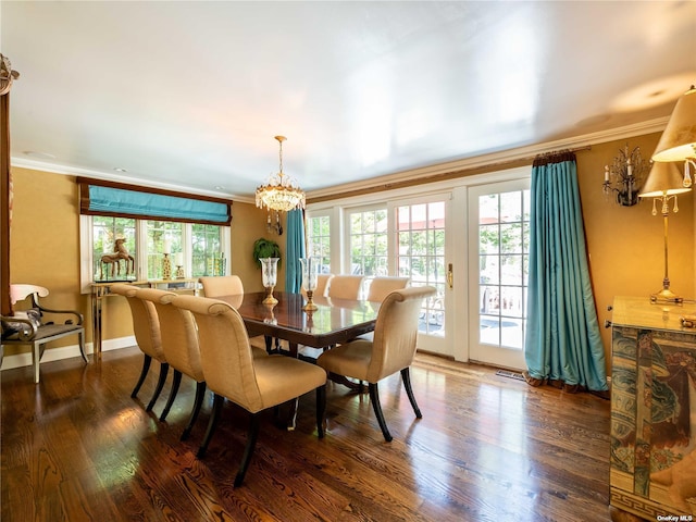 dining room with ornamental molding, dark wood-style flooring, and a healthy amount of sunlight