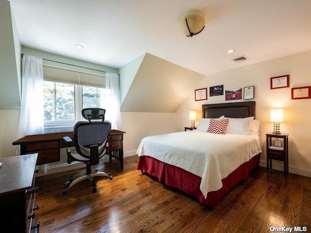 bedroom with lofted ceiling, baseboards, visible vents, and dark wood-style flooring