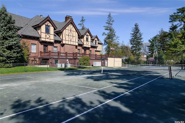 view of tennis court with fence