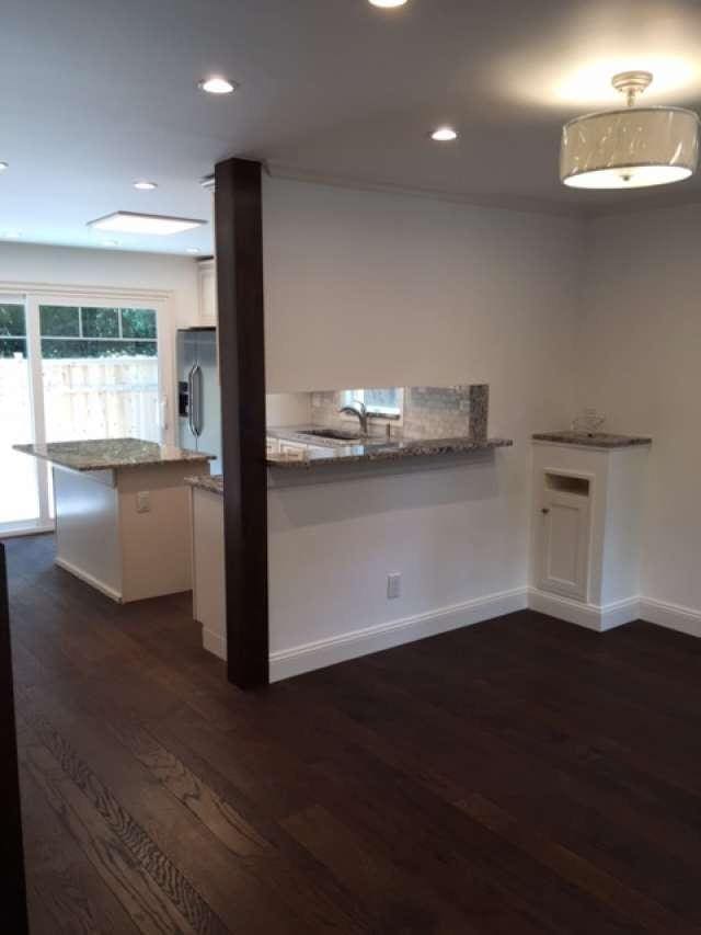 kitchen featuring dark hardwood / wood-style flooring, stainless steel fridge, sink, light stone counters, and white cabinets