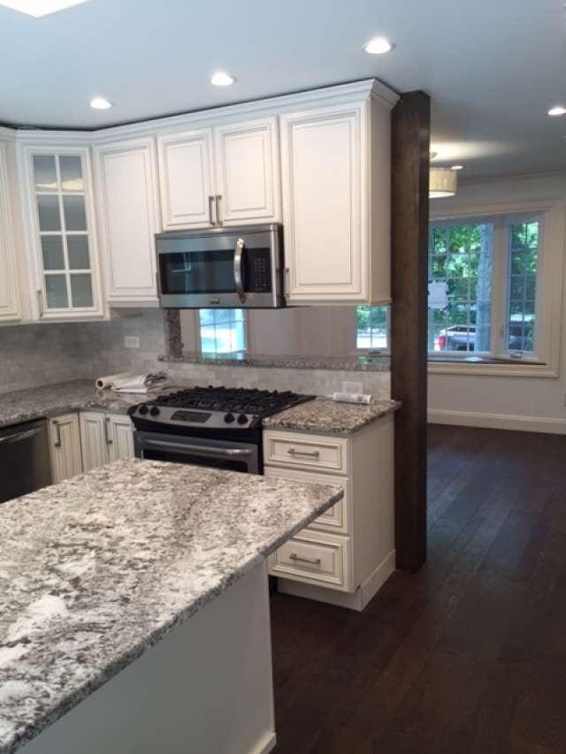 kitchen featuring white cabinetry, stainless steel appliances, and light stone countertops