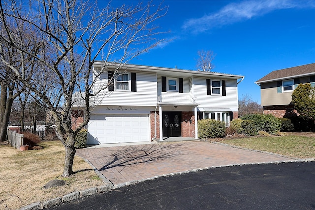 view of front of house with a front lawn, decorative driveway, brick siding, and an attached garage