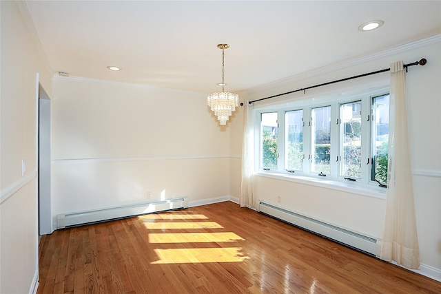 unfurnished room with baseboard heating, crown molding, a baseboard heating unit, and wood finished floors