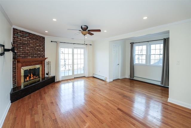 unfurnished living room featuring a baseboard heating unit, a ceiling fan, and crown molding