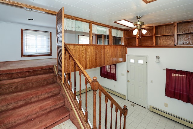 entrance foyer featuring stairway, baseboard heating, and ceiling fan