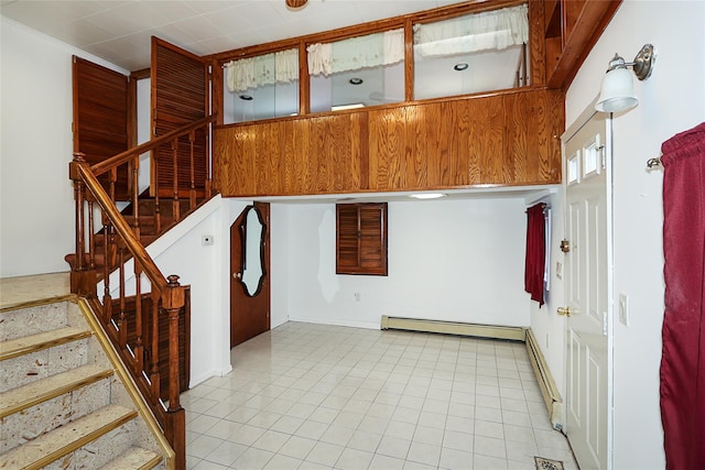 stairs featuring tile patterned floors and a baseboard radiator