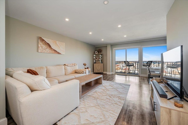 living area with recessed lighting, baseboards, and wood finished floors