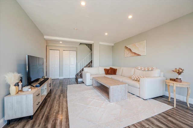 living room with stairs, baseboards, dark wood-style flooring, and recessed lighting