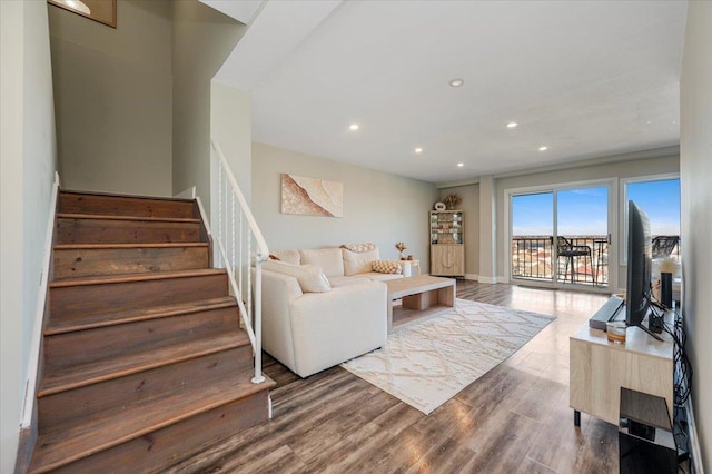 living room with stairs, recessed lighting, baseboards, and wood finished floors