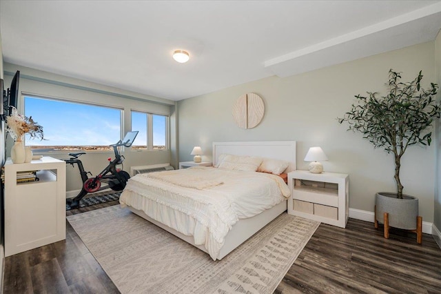 bedroom featuring dark wood-style flooring and baseboards