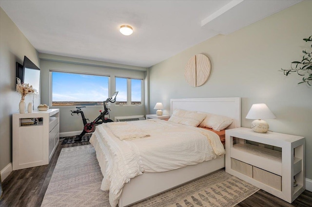 bedroom featuring baseboards and wood finished floors