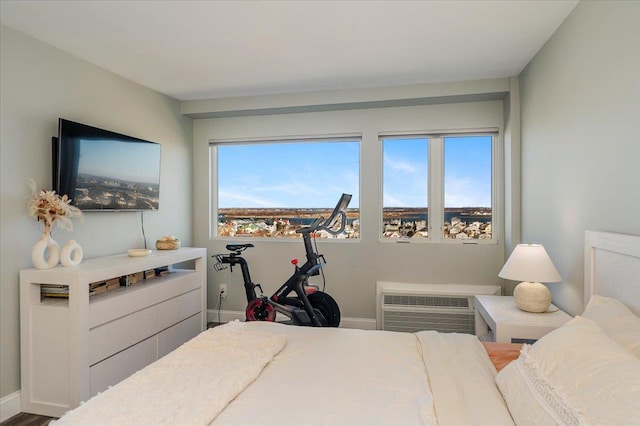 bedroom featuring baseboards and a wall mounted air conditioner