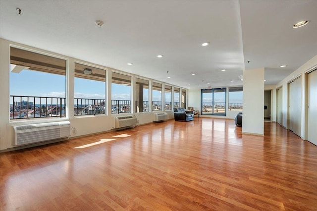 interior space with a wealth of natural light, light wood-type flooring, and recessed lighting