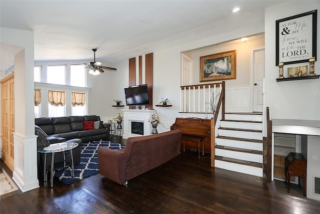59 Lauren Ave, Dix Hills, NY 11746 - living area featuring a fireplace, a ceiling fan, stairway, wainscoting, and hardwood / wood-style floors