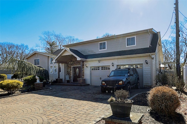 view of front of property featuring decorative driveway and an attached garage