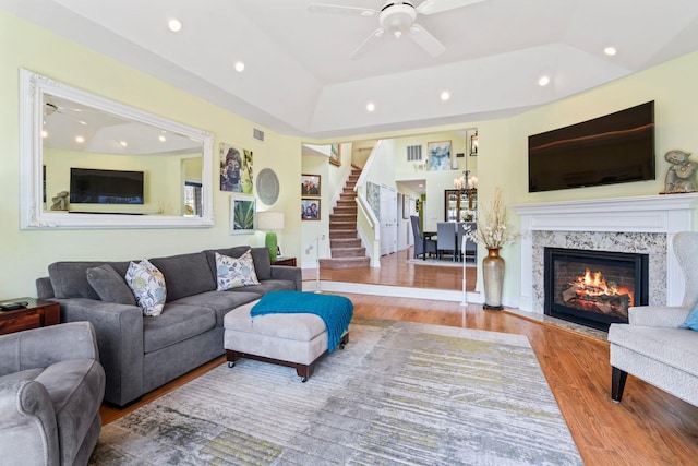 living room with recessed lighting, ceiling fan, stairway, and wood finished floors