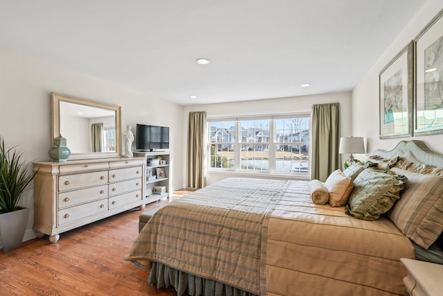 bedroom with recessed lighting and wood finished floors