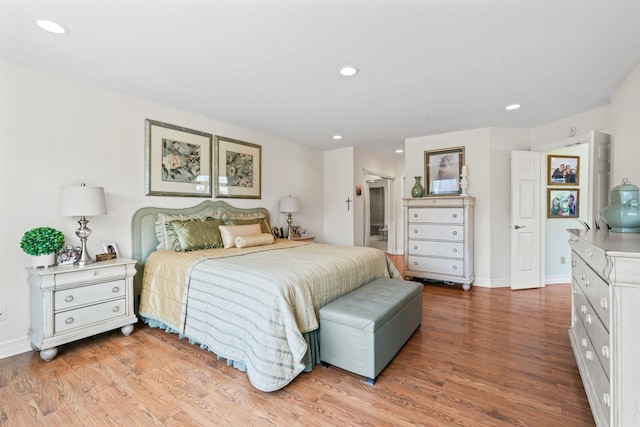 bedroom with baseboards, light wood-type flooring, and recessed lighting